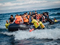 Volunteer lifeguards bring a stranded boat safely to the Greek island of Lesbos, on September 30, 2015.  (