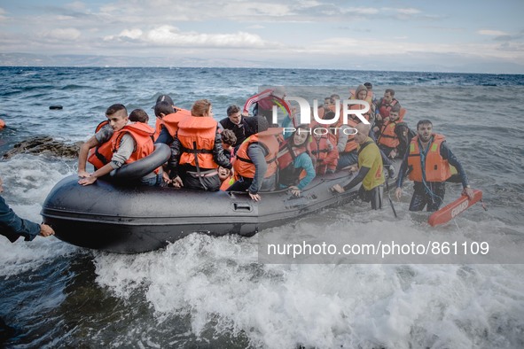 Volunteer lifeguards bring a stranded boat safely to the Greek island of Lesbos, on September 30, 2015.  