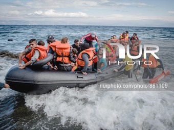 Volunteer lifeguards bring a stranded boat safely to the Greek island of Lesbos, on September 30, 2015.  (