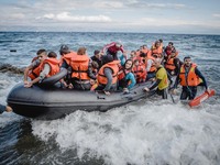 Volunteer lifeguards bring a stranded boat safely to the Greek island of Lesbos, on September 30, 2015.  (