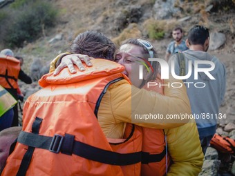 Two women react after arriving on the shore of the Greek island of Lesbos, on September 30, 2015.  (