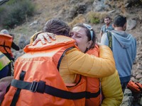 Two women react after arriving on the shore of the Greek island of Lesbos, on September 30, 2015.  (