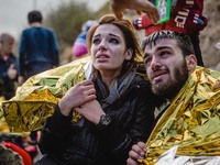 Migrants react after arriving on the shore of the Greek island of Lesbos, on September 30, 2015.  (