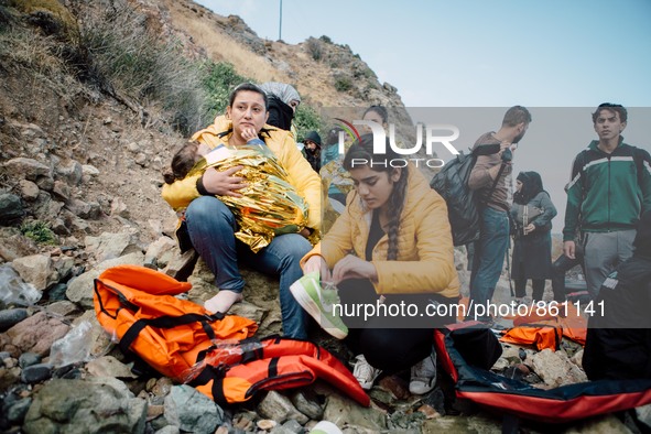 A child wrapped in a thermal blanket rests in her mother’s arms before continuing the journey, on September 30, 2015.  