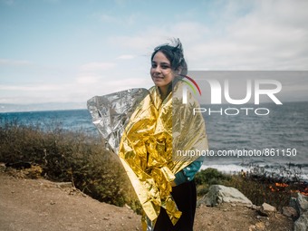 A child wrapped in a thermal blanket along the coast of Lesbos, Greece, on September 30, 2015.  (