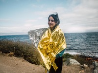 A child wrapped in a thermal blanket along the coast of Lesbos, Greece, on September 30, 2015.  (