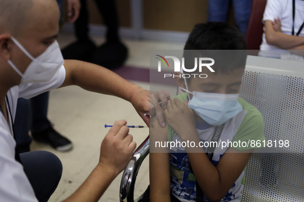 A child receives the first dose of Pfizer's during the pediatric vaccination campaign for children under 8 years of age   against Covid19 at...