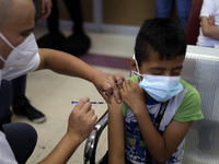 A child receives the first dose of Pfizer's during the pediatric vaccination campaign for children under 8 years of age   against Covid19 at...