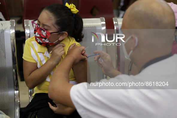 A child receives the first dose of Pfizer's during the pediatric vaccination campaign for children under 8 years of age   against Covid19 at...