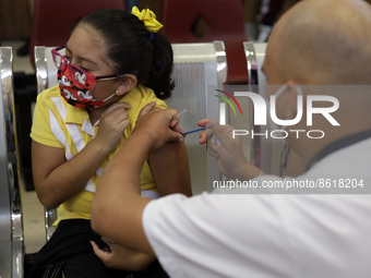 A child receives the first dose of Pfizer's during the pediatric vaccination campaign for children under 8 years of age   against Covid19 at...