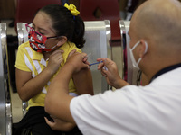 A child receives the first dose of Pfizer's during the pediatric vaccination campaign for children under 8 years of age   against Covid19 at...