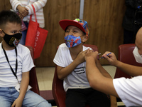 A child receives the first dose of Pfizer's during the pediatric vaccination campaign for children under 8 years of age   against Covid19 at...