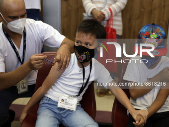 A child receives the first dose of Pfizer's during the pediatric vaccination campaign for children under 8 years of age   against Covid19 at...