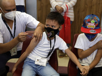 A child receives the first dose of Pfizer's during the pediatric vaccination campaign for children under 8 years of age   against Covid19 at...