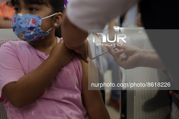 A child receives the first dose of Pfizer's during the pediatric vaccination campaign for children under 8 years of age   against Covid19 at...