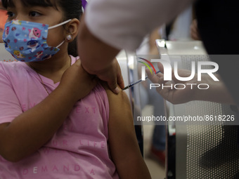 A child receives the first dose of Pfizer's during the pediatric vaccination campaign for children under 8 years of age   against Covid19 at...