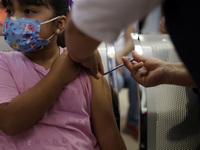 A child receives the first dose of Pfizer's during the pediatric vaccination campaign for children under 8 years of age   against Covid19 at...