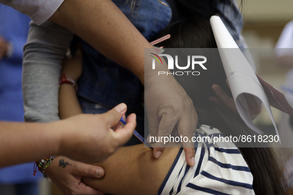 A child receives the first dose of Pfizer's during the pediatric vaccination campaign for children under 8 years of age   against Covid19 at...