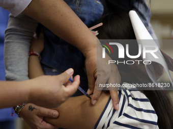 A child receives the first dose of Pfizer's during the pediatric vaccination campaign for children under 8 years of age   against Covid19 at...