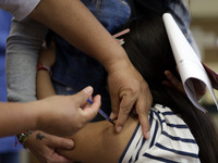 A child receives the first dose of Pfizer's during the pediatric vaccination campaign for children under 8 years of age   against Covid19 at...