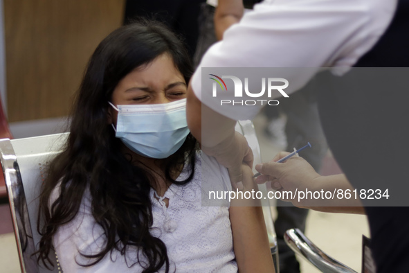 A child receives the first dose of Pfizer's during the pediatric vaccination campaign for children under 8 years of age   against Covid19 at...