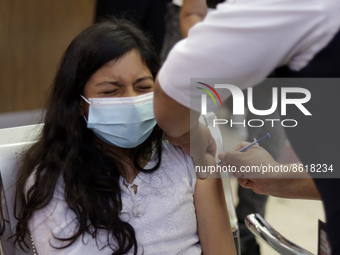 A child receives the first dose of Pfizer's during the pediatric vaccination campaign for children under 8 years of age   against Covid19 at...