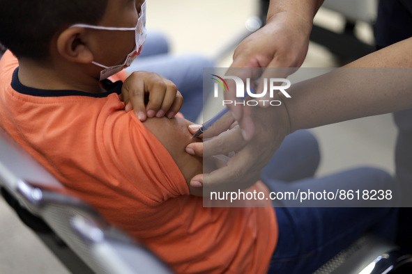 A child receives the first dose of Pfizer's during the pediatric vaccination campaign for children under 8 years of age   against Covid19 at...