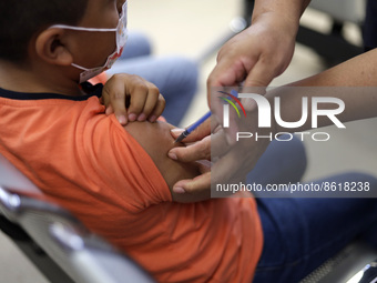 A child receives the first dose of Pfizer's during the pediatric vaccination campaign for children under 8 years of age   against Covid19 at...