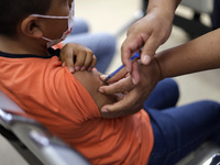 A child receives the first dose of Pfizer's during the pediatric vaccination campaign for children under 8 years of age   against Covid19 at...