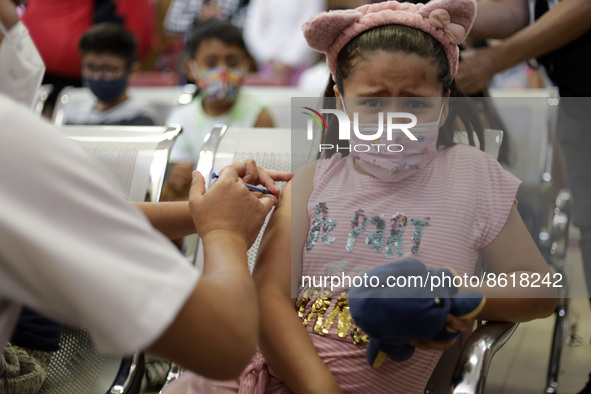 A child receives the first dose of Pfizer's during the pediatric vaccination campaign for children under 8 years of age   against Covid19 at...