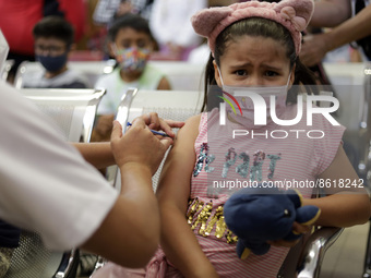 A child receives the first dose of Pfizer's during the pediatric vaccination campaign for children under 8 years of age   against Covid19 at...