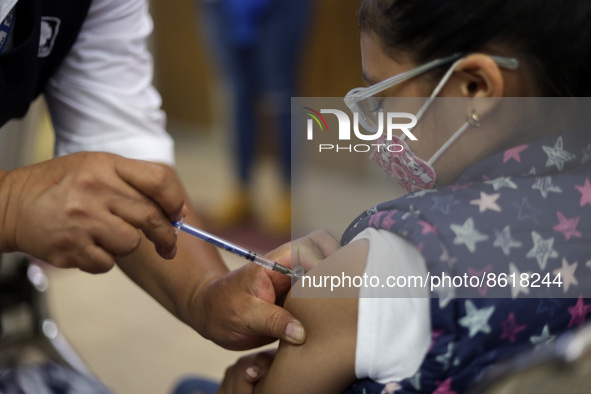 A child receives the first dose of Pfizer's during the pediatric vaccination campaign for children under 8 years of age   against Covid19 at...