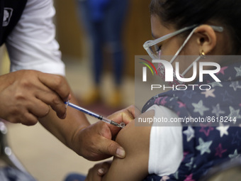 A child receives the first dose of Pfizer's during the pediatric vaccination campaign for children under 8 years of age   against Covid19 at...