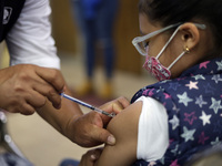 A child receives the first dose of Pfizer's during the pediatric vaccination campaign for children under 8 years of age   against Covid19 at...