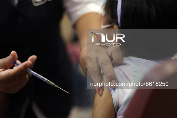 A child receives the first dose of Pfizer's during the pediatric vaccination campaign for children under 8 years of age   against Covid19 at...