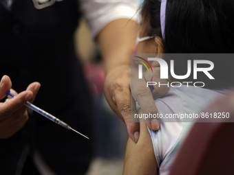 A child receives the first dose of Pfizer's during the pediatric vaccination campaign for children under 8 years of age   against Covid19 at...