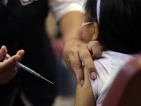 A child receives the first dose of Pfizer's during the pediatric vaccination campaign for children under 8 years of age   against Covid19 at...