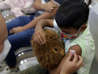 A child receives the first dose of Pfizer's during the pediatric vaccination campaign for children under 8 years of age   against Covid19 at...