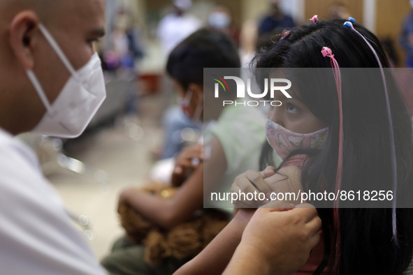 A child receives the first dose of Pfizer's during the pediatric vaccination campaign for children under 8 years of age   against Covid19 at...