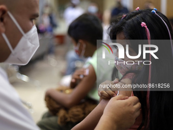 A child receives the first dose of Pfizer's during the pediatric vaccination campaign for children under 8 years of age   against Covid19 at...