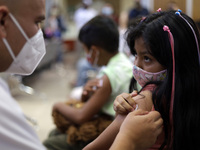 A child receives the first dose of Pfizer's during the pediatric vaccination campaign for children under 8 years of age   against Covid19 at...