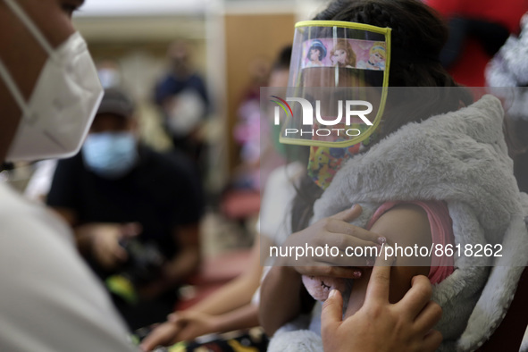 A child receives the first dose of Pfizer's during the pediatric vaccination campaign for children under 8 years of age   against Covid19 at...