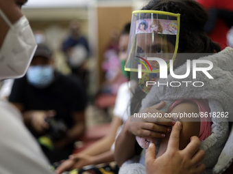 A child receives the first dose of Pfizer's during the pediatric vaccination campaign for children under 8 years of age   against Covid19 at...