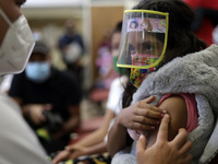 A child receives the first dose of Pfizer's during the pediatric vaccination campaign for children under 8 years of age   against Covid19 at...