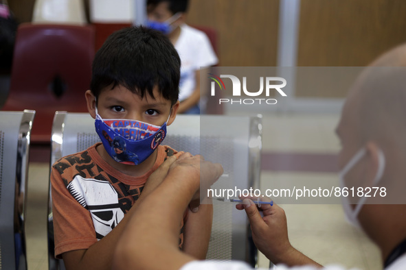 A child receives the first dose of Pfizer's during the pediatric vaccination campaign for children under 8 years of age   against Covid19 at...