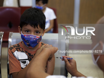 A child receives the first dose of Pfizer's during the pediatric vaccination campaign for children under 8 years of age   against Covid19 at...