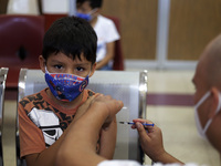 A child receives the first dose of Pfizer's during the pediatric vaccination campaign for children under 8 years of age   against Covid19 at...