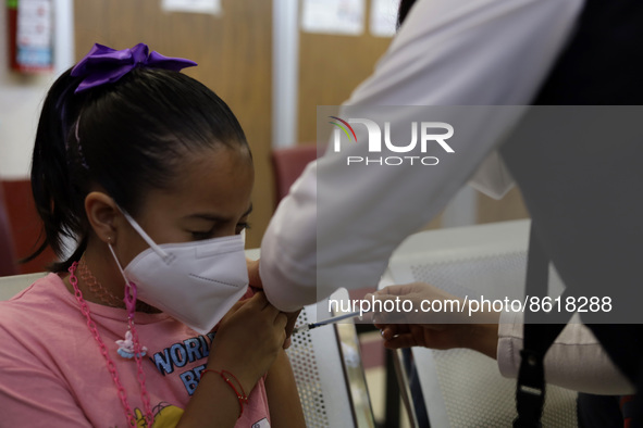 A child receives the first dose of Pfizer's during the pediatric vaccination campaign for children under 8 years of age   against Covid19 at...