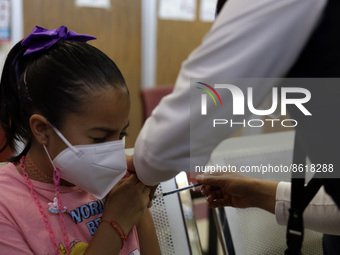 A child receives the first dose of Pfizer's during the pediatric vaccination campaign for children under 8 years of age   against Covid19 at...