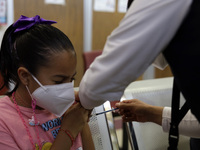 A child receives the first dose of Pfizer's during the pediatric vaccination campaign for children under 8 years of age   against Covid19 at...